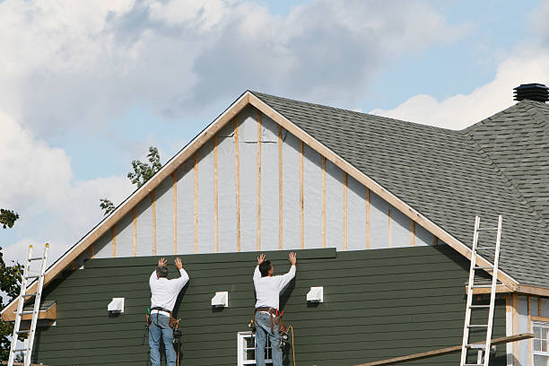 Professional Storm Damage Siding Repair technician working in Schellsburg, PA